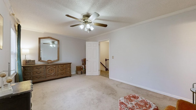 bedroom featuring ceiling fan, crown molding, light carpet, and a textured ceiling