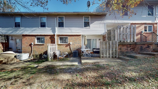 back of property featuring central AC unit