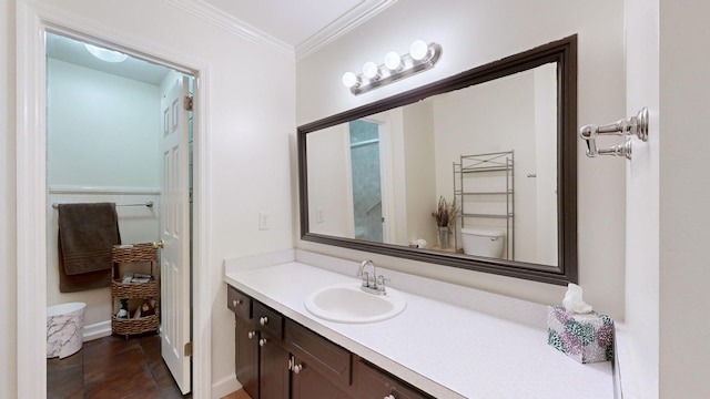 bathroom featuring crown molding, vanity, and toilet