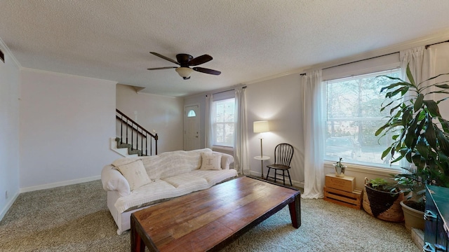 carpeted living room featuring a wealth of natural light, ceiling fan, and a textured ceiling