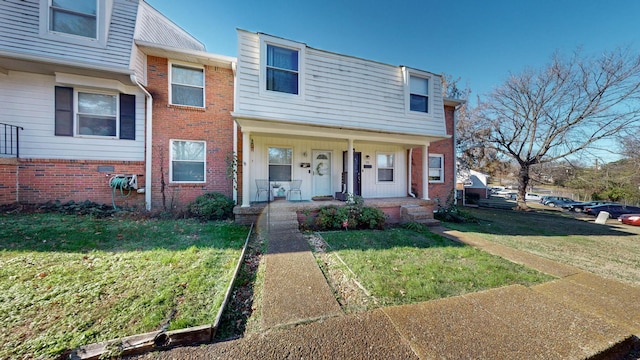 view of front of home with a front lawn and a porch