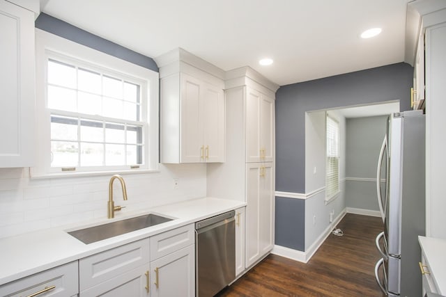 kitchen featuring white cabinetry, appliances with stainless steel finishes, sink, and dark hardwood / wood-style floors