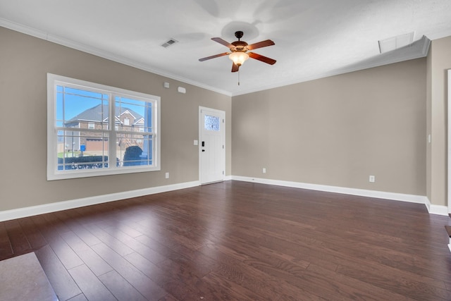 empty room with ceiling fan, dark hardwood / wood-style flooring, and ornamental molding