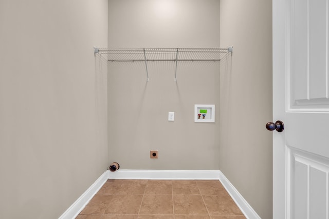 laundry area featuring electric dryer hookup, washer hookup, and light tile patterned floors