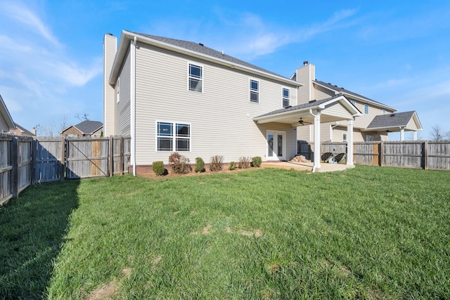 back of house with french doors, a yard, ceiling fan, and a patio area