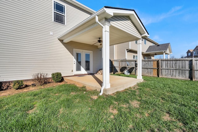 back of house featuring french doors, ceiling fan, a patio, and a lawn