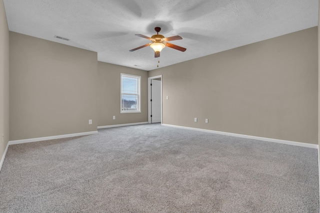 carpeted spare room with ceiling fan and a textured ceiling