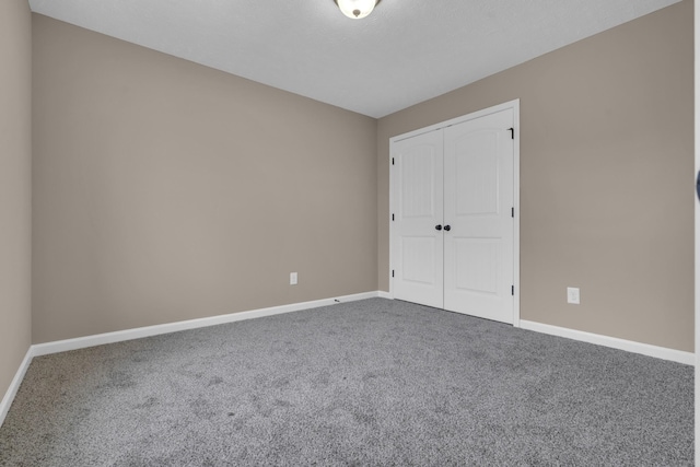 unfurnished bedroom featuring carpet floors and a closet