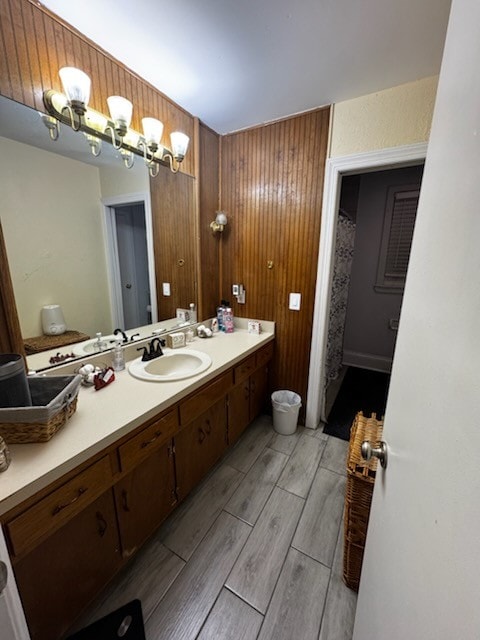 bathroom featuring vanity, wooden walls, and wood-type flooring