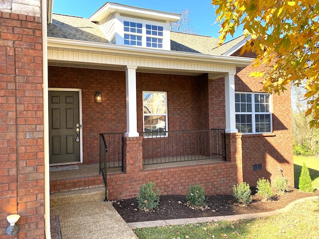 view of exterior entry with a porch