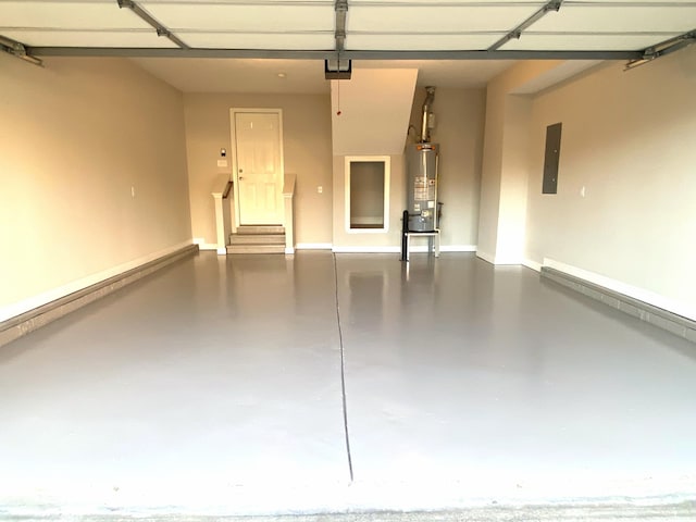 garage featuring electric panel and water heater