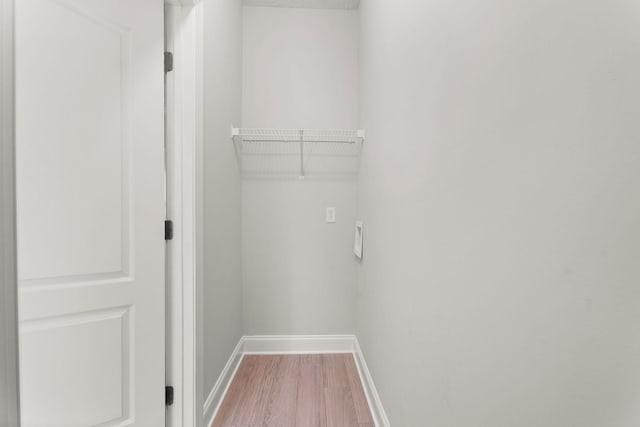 laundry area featuring hardwood / wood-style flooring