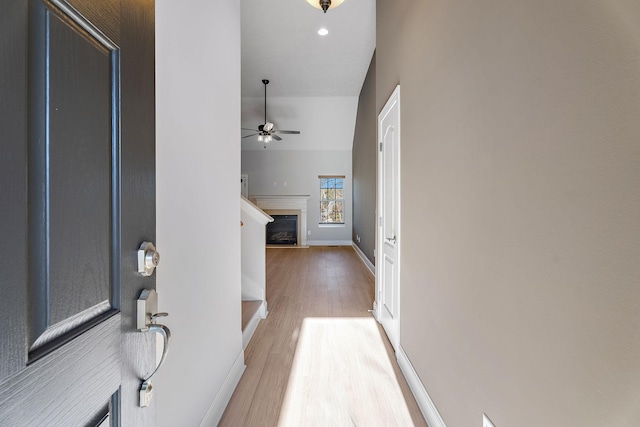 foyer entrance featuring ceiling fan and wood-type flooring