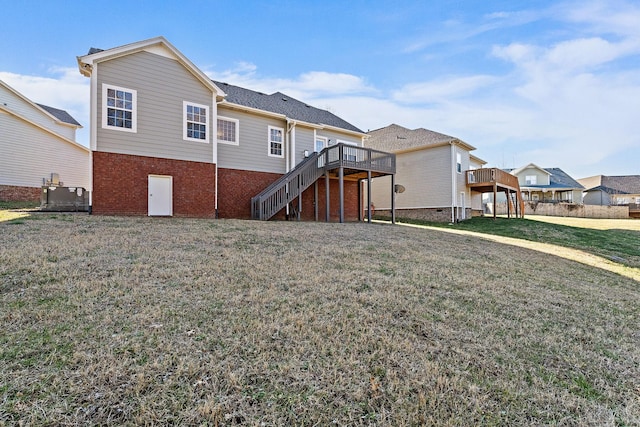 rear view of property featuring a wooden deck, a yard, and central air condition unit