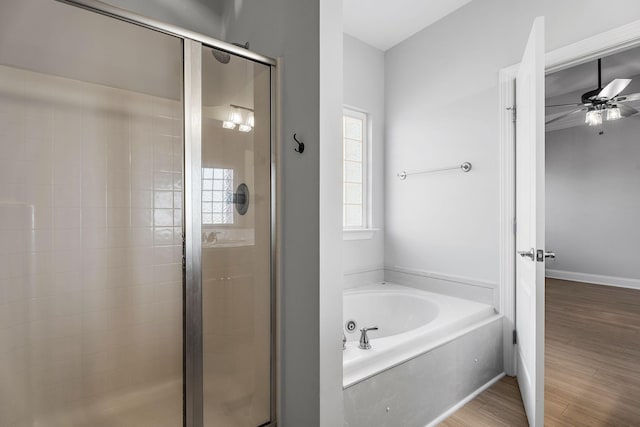 bathroom with shower with separate bathtub, hardwood / wood-style floors, and ceiling fan