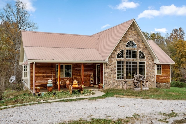 back of property featuring covered porch