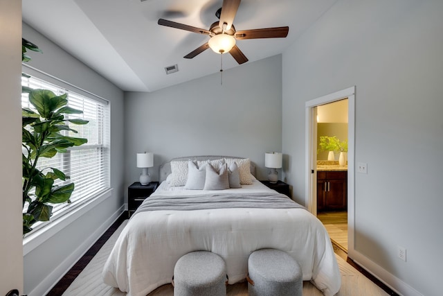 bedroom featuring wood-type flooring, vaulted ceiling, ceiling fan, and ensuite bathroom