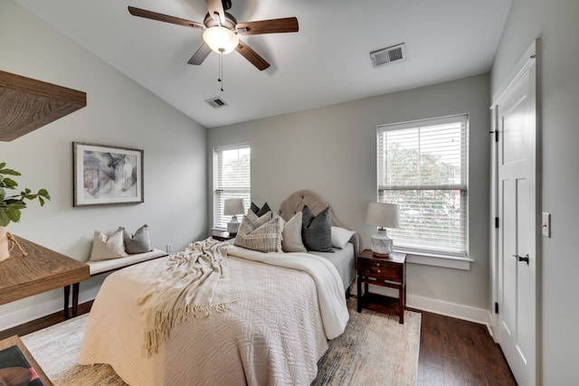 bedroom with dark wood-type flooring, lofted ceiling, and ceiling fan