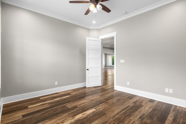 unfurnished room with ceiling fan, dark hardwood / wood-style floors, and crown molding