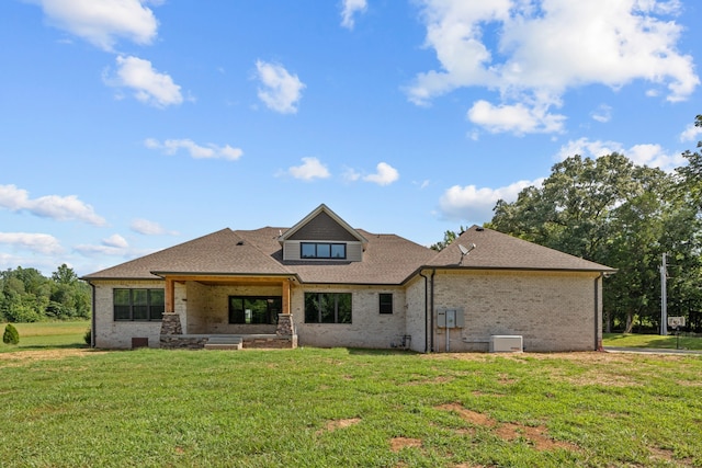 rear view of property with a yard