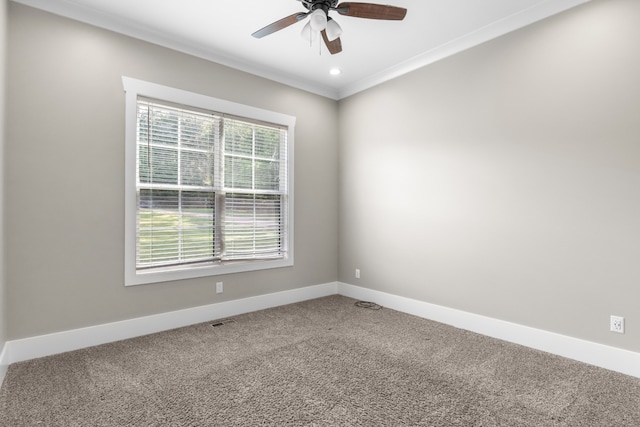 spare room featuring carpet flooring, ceiling fan, and crown molding