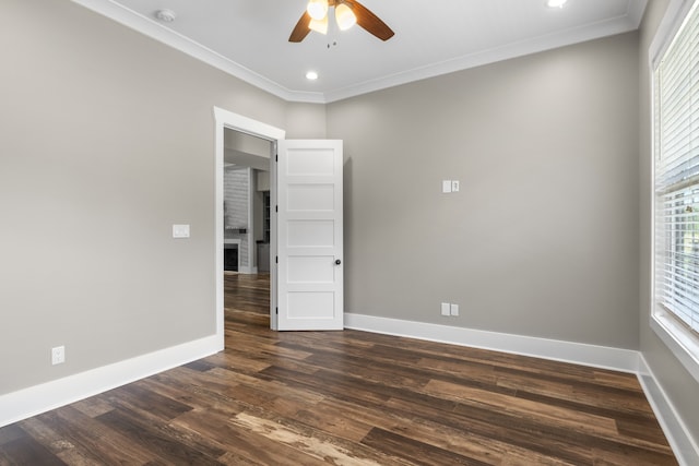 spare room with ornamental molding, dark wood-type flooring, and ceiling fan