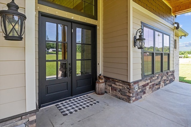 property entrance featuring french doors and covered porch