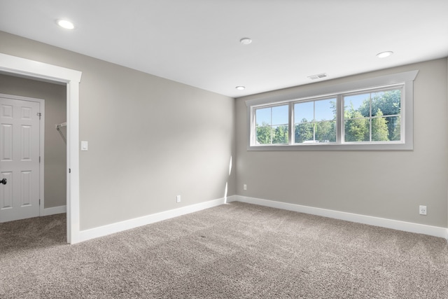 unfurnished room featuring a wealth of natural light and carpet