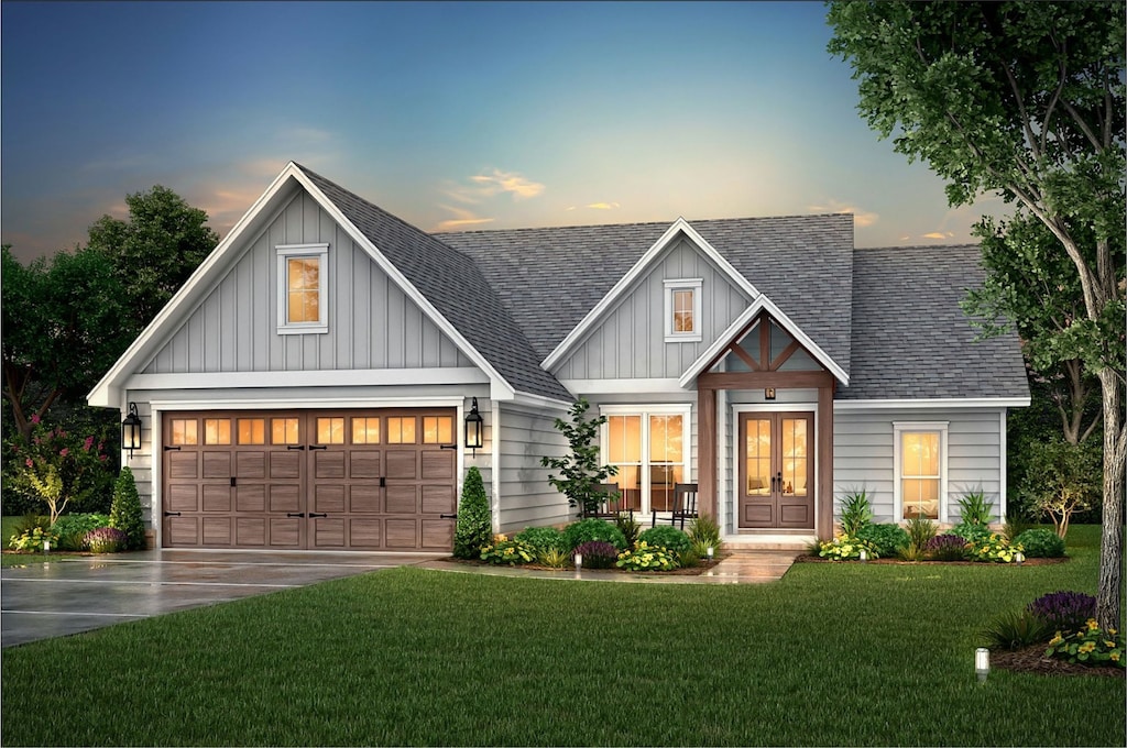 view of front of home featuring a garage and a lawn