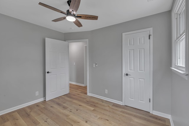 unfurnished bedroom with ceiling fan and light hardwood / wood-style flooring