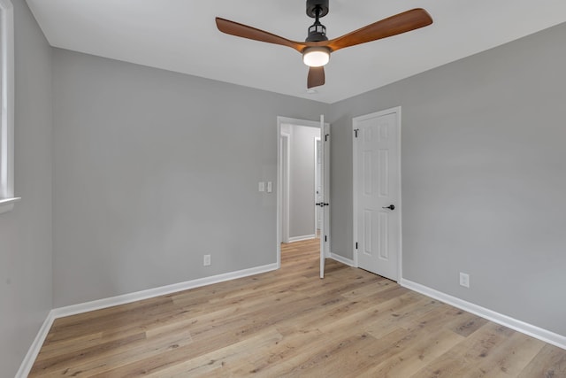 spare room with light wood-type flooring and ceiling fan