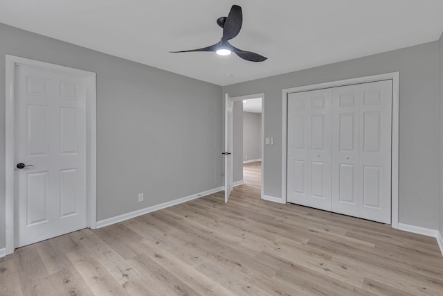 unfurnished bedroom with a closet, light hardwood / wood-style floors, and ceiling fan