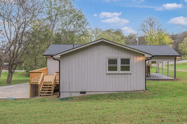 view of property exterior with a patio, a wooden deck, and a yard