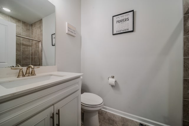 bathroom with toilet, vanity, tile patterned floors, and an enclosed shower