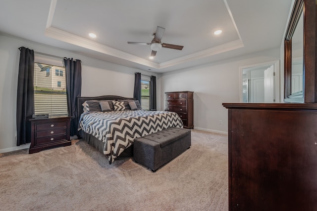 bedroom with light colored carpet, a raised ceiling, ceiling fan, and crown molding