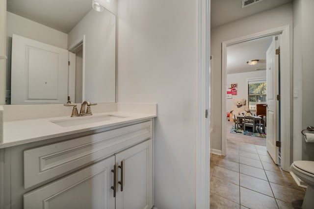 bathroom featuring tile patterned flooring, vanity, and toilet