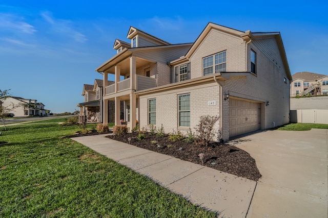 view of front of property with a front yard, a balcony, and a garage