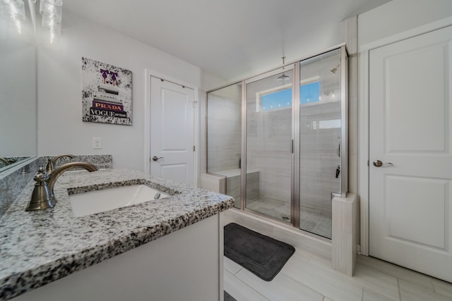 bathroom with tile patterned floors, vanity, and walk in shower