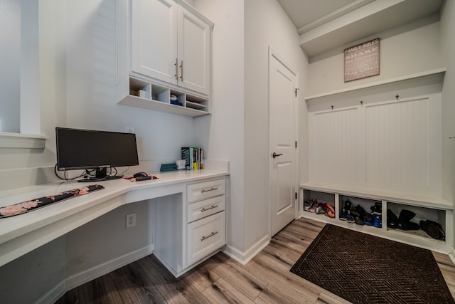 office space with built in desk and hardwood / wood-style flooring