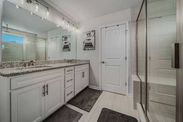 bathroom featuring vanity and an enclosed shower