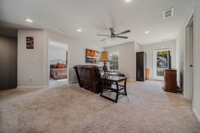 carpeted living room featuring ceiling fan