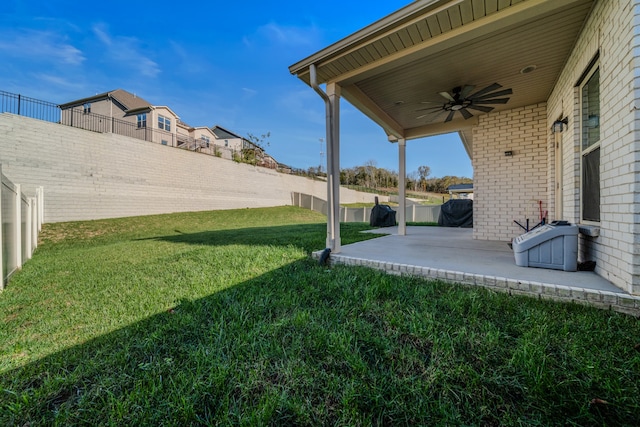 view of yard featuring a patio area and ceiling fan