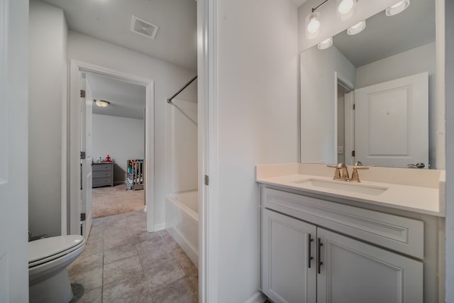 bathroom with tile patterned floors, vanity, and toilet