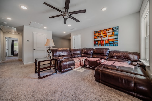 carpeted living room featuring ceiling fan