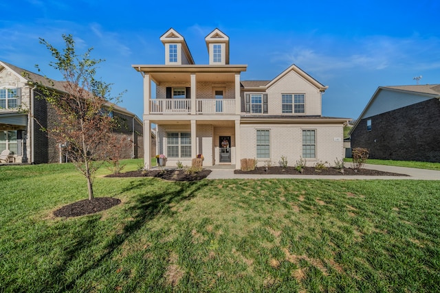 view of front of house featuring a front yard and a balcony