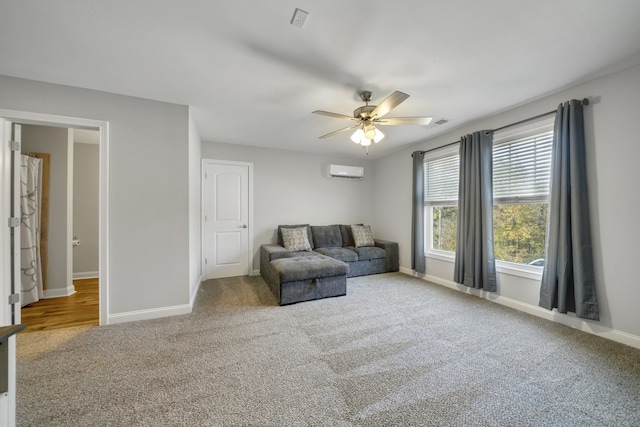 living area with an AC wall unit, ceiling fan, and carpet floors