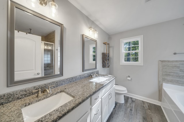 full bathroom with vanity, hardwood / wood-style flooring, toilet, and plus walk in shower