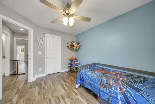 bedroom with ceiling fan and wood-type flooring