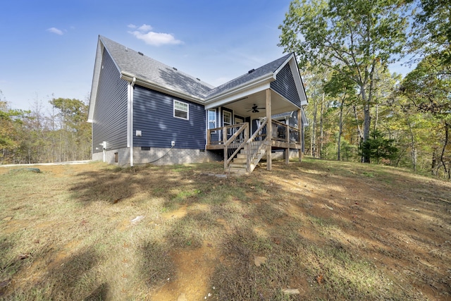 rear view of property with ceiling fan