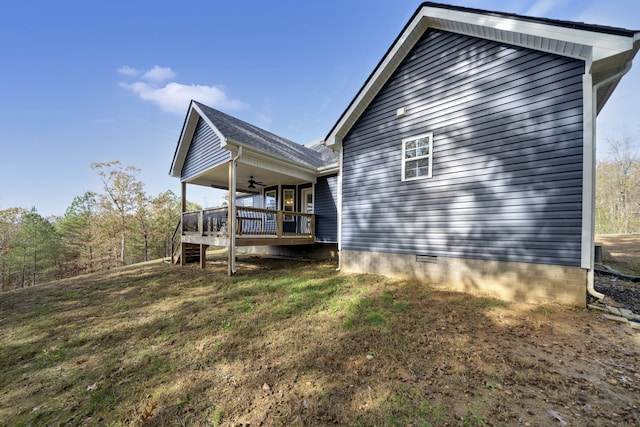 back of house featuring a yard, ceiling fan, and a deck